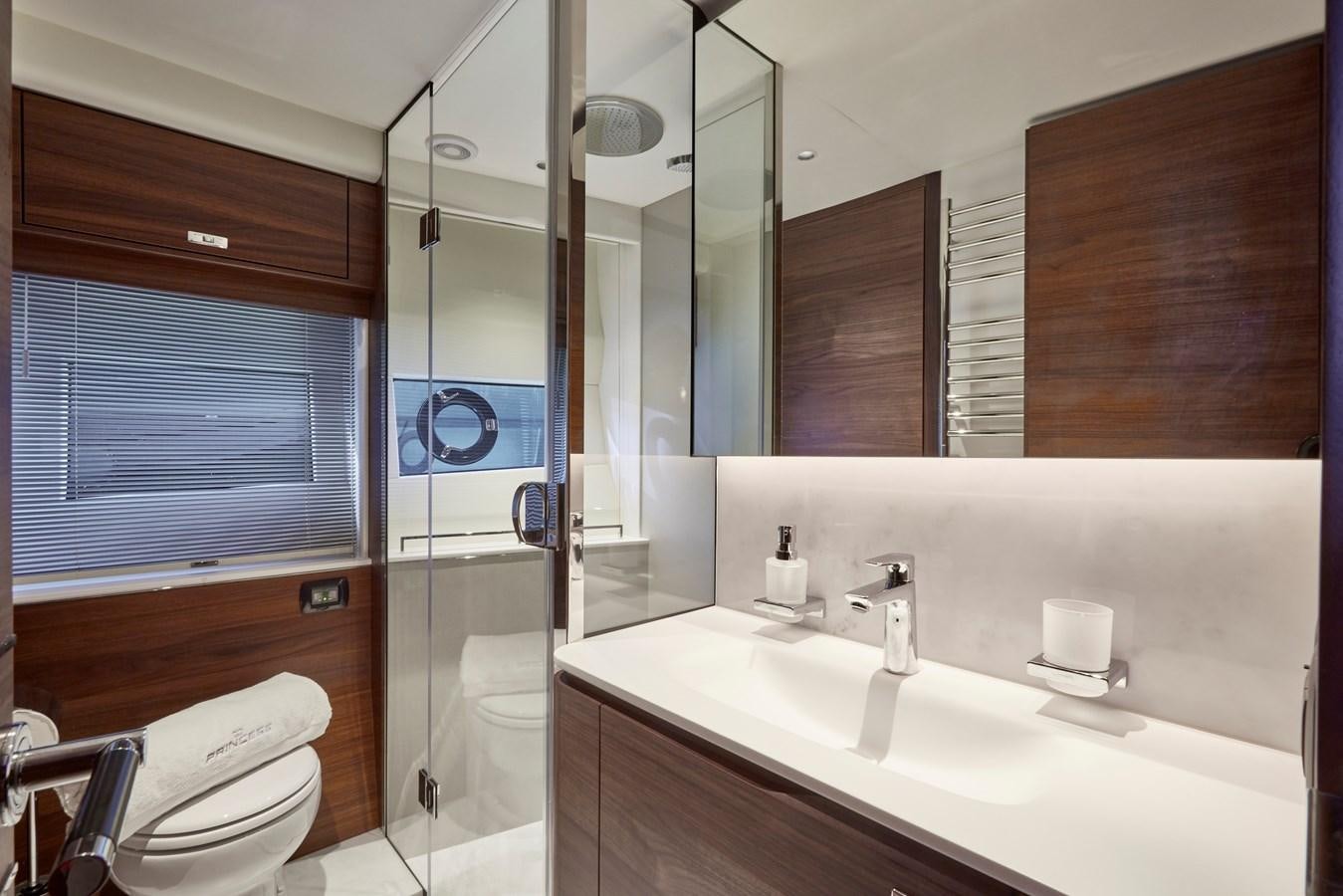 a bathroom with a glass shower aboard VENTURE Yacht for Sale