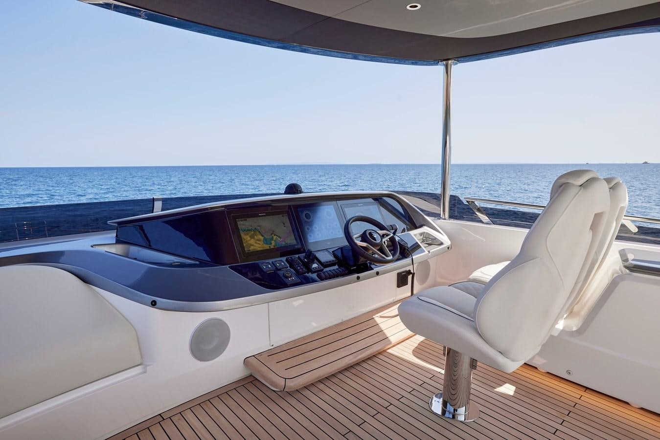 a white chair next to a white bathtub with a large white chair aboard VENTURE Yacht for Sale