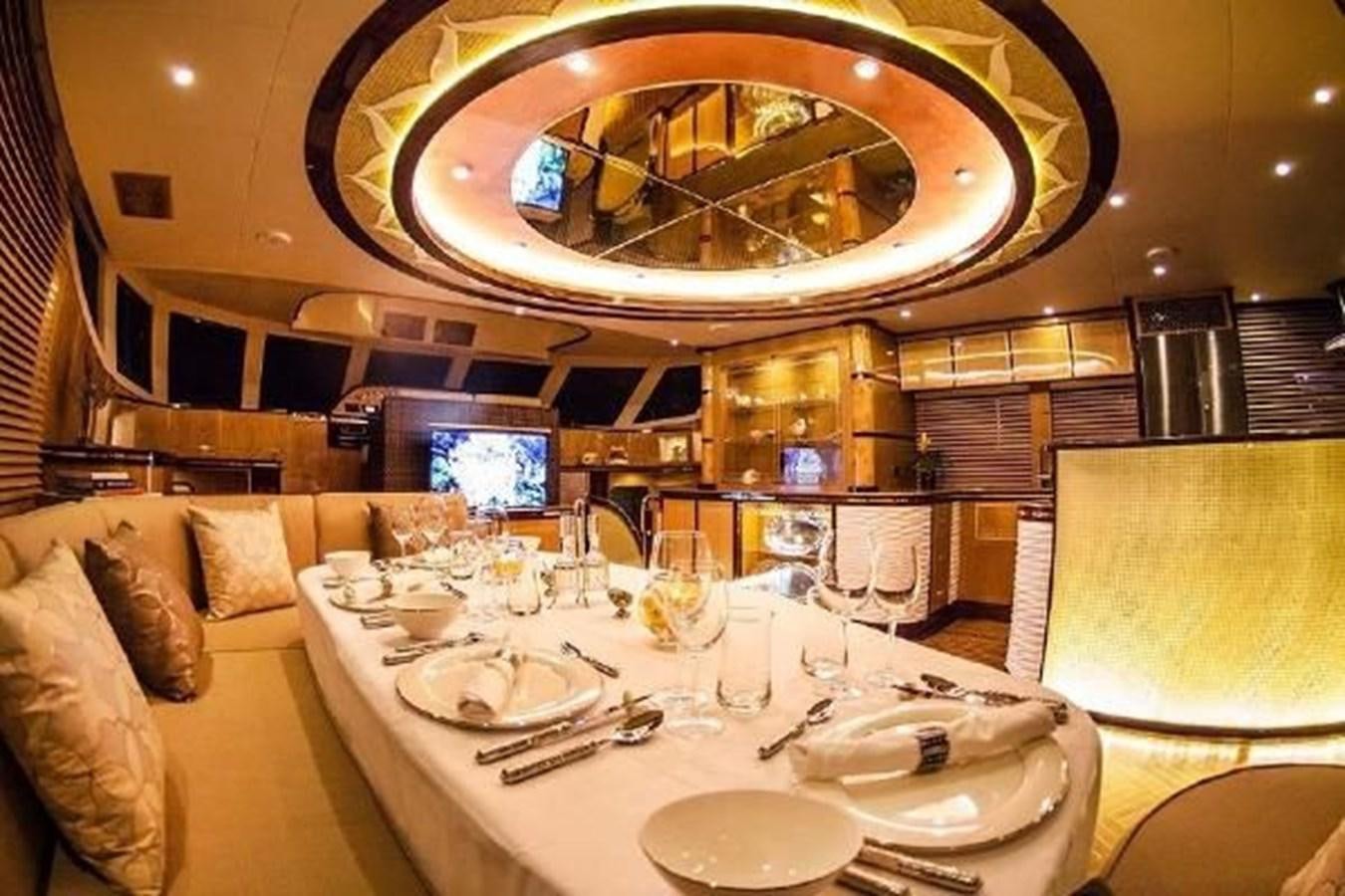 a fancy dining room with a chandelier aboard 2021 HELIOTROPE NL 70 SOLAR ELECTRIC Yacht for Sale
