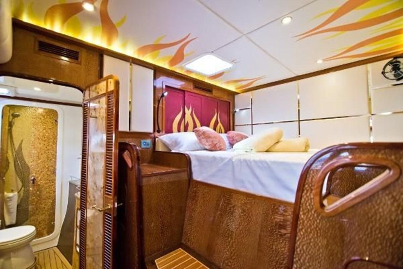 a bedroom with a bed and a mirror aboard 2021 HELIOTROPE NL 70 SOLAR ELECTRIC Yacht for Sale
