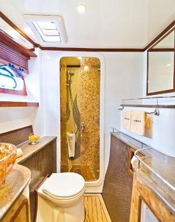 a bathroom with a toilet and sink aboard 2021 HELIOTROPE NL 70 SOLAR ELECTRIC Yacht for Sale