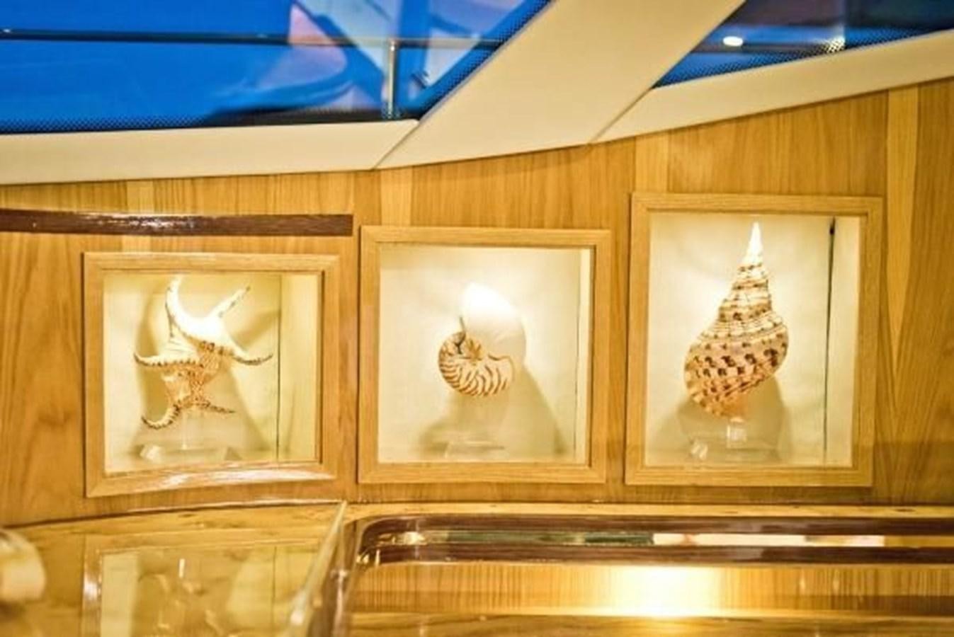 a group of paintings on a wall aboard 2021 HELIOTROPE NL 70 SOLAR ELECTRIC Yacht for Sale