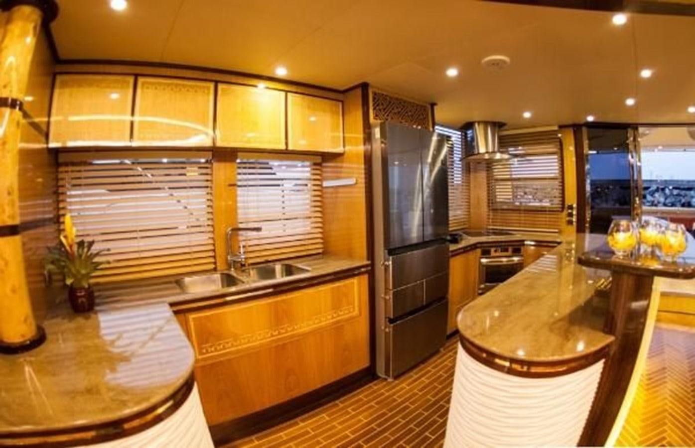 a kitchen with a large island aboard 2021 HELIOTROPE NL 70 SOLAR ELECTRIC Yacht for Sale
