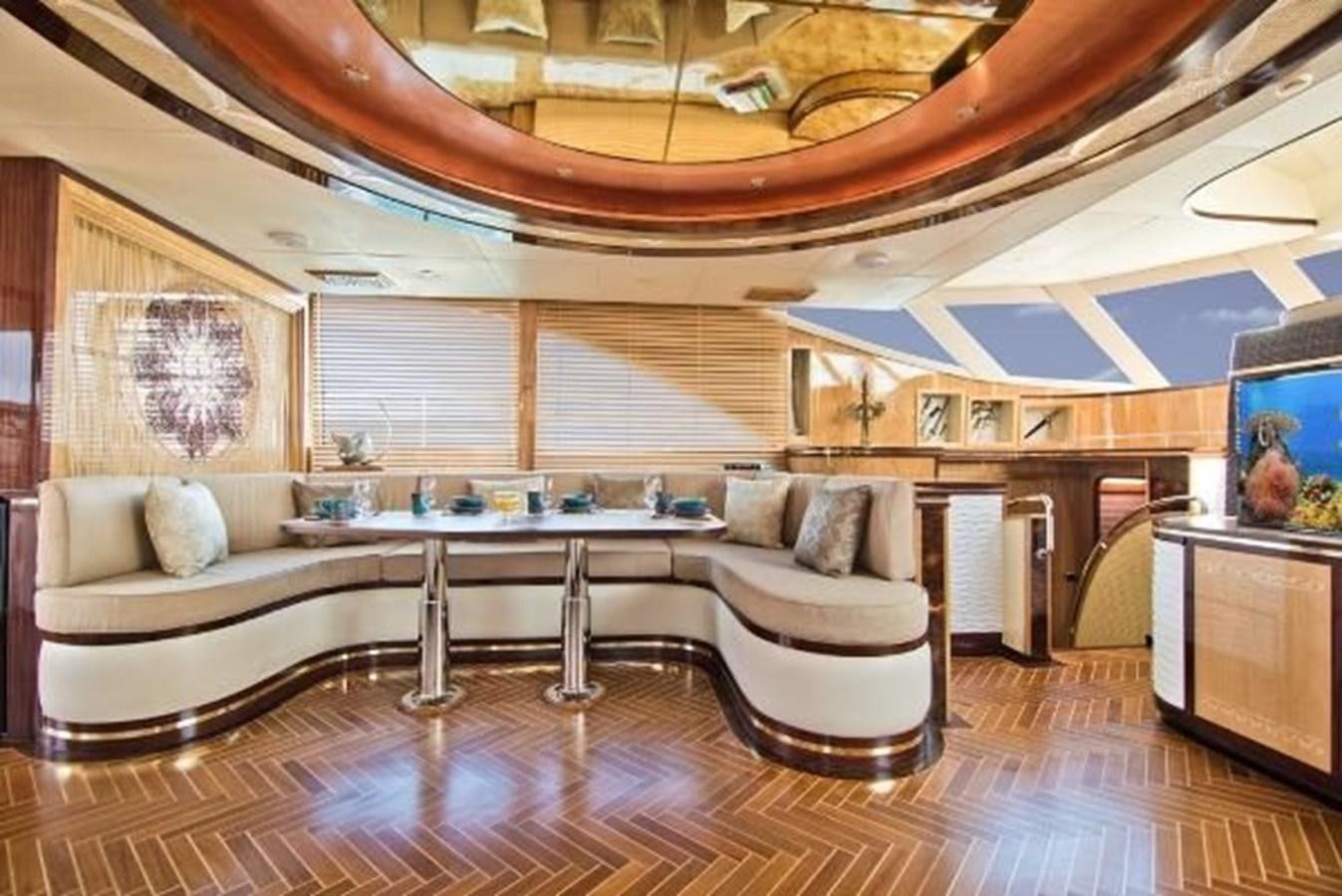 a living room with a large table and couches aboard 2021 HELIOTROPE NL 70 SOLAR ELECTRIC Yacht for Sale