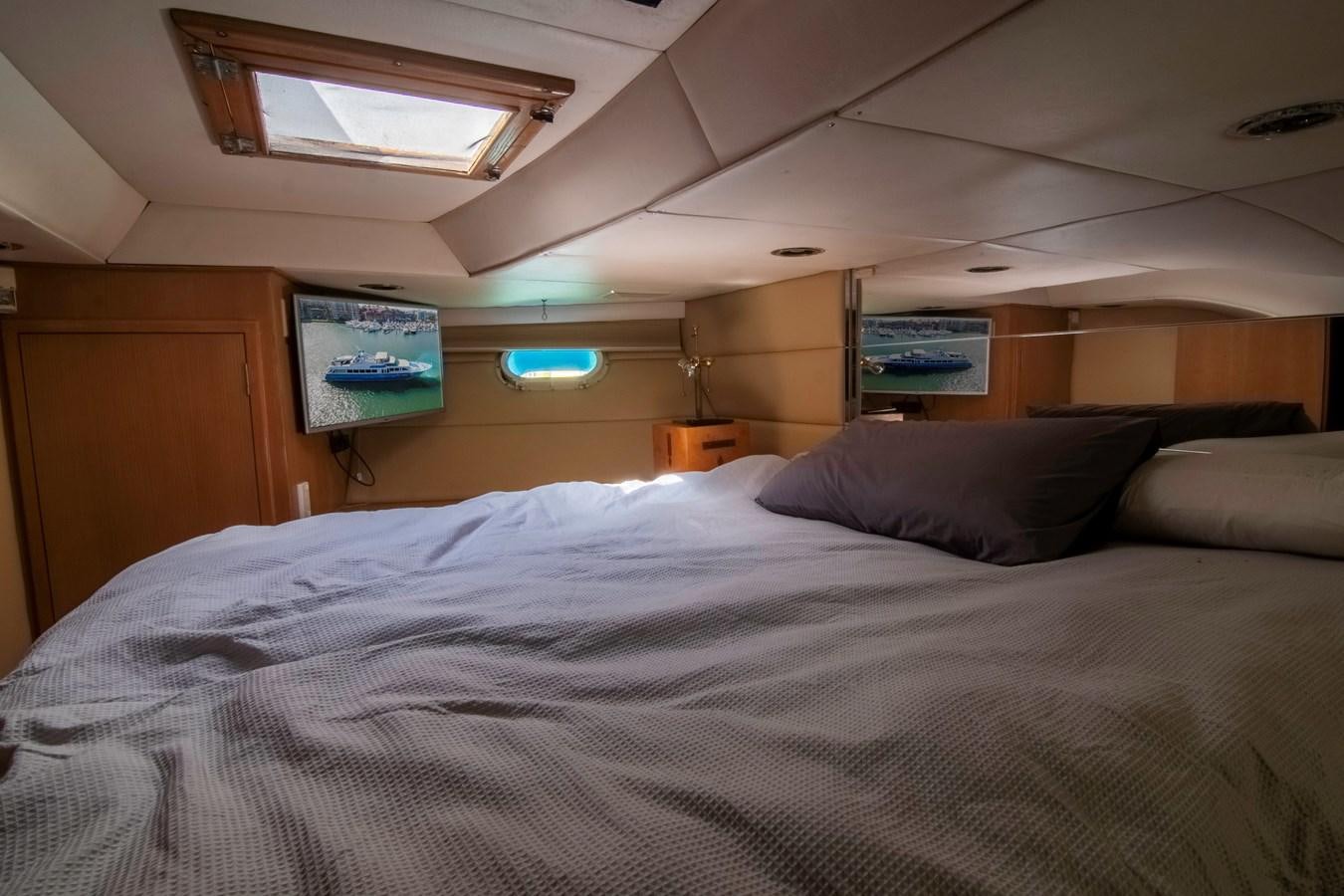 a bed with a white comforter aboard LADY AUDREY Yacht for Sale