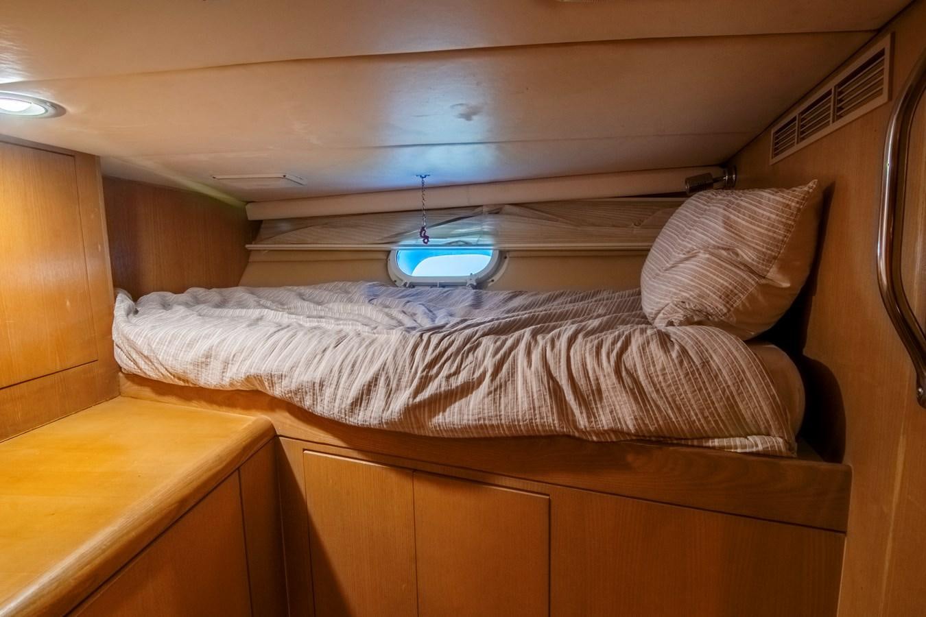 a bed with a white pillow aboard LADY AUDREY Yacht for Sale