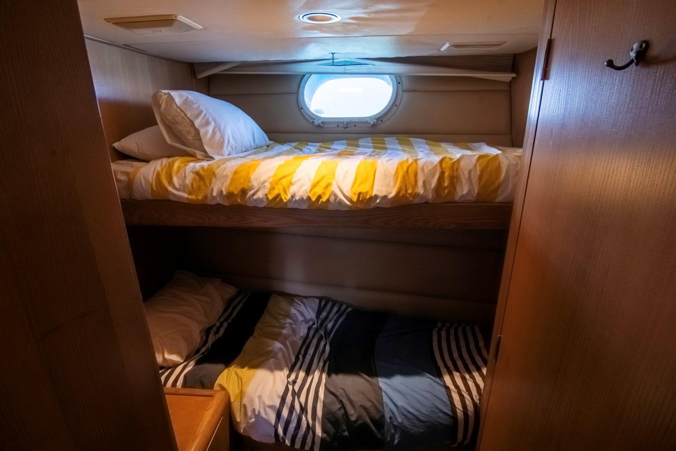 a bed with yellow sheets aboard LADY AUDREY Yacht for Sale