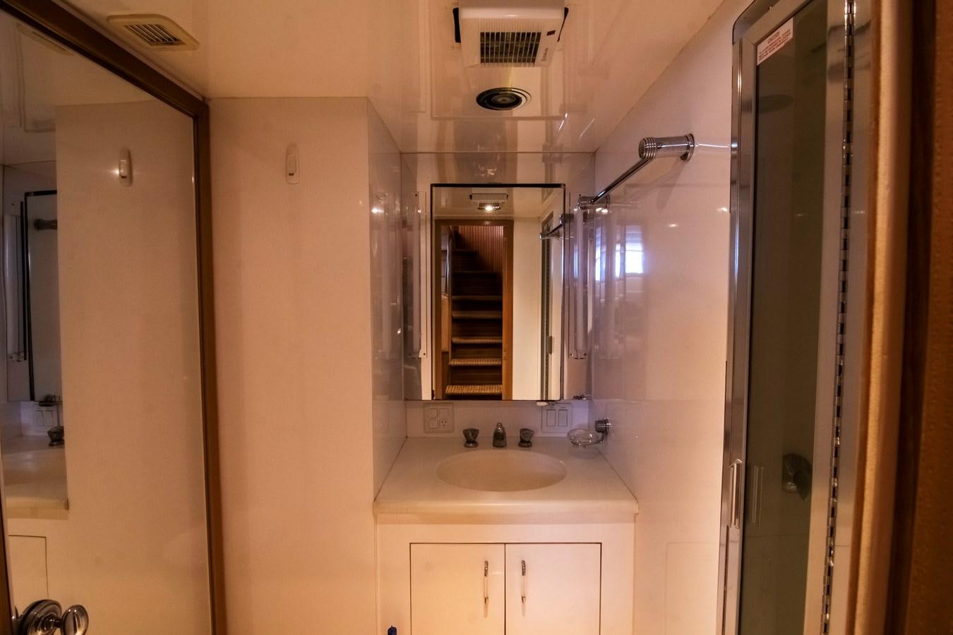 a bathroom with a sink and a mirror aboard LADY AUDREY Yacht for Sale