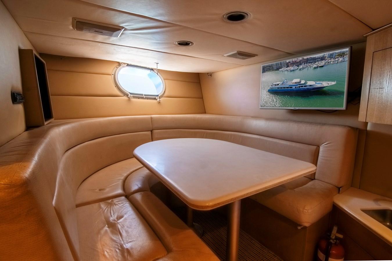 a room with a table and chairs aboard LADY AUDREY Yacht for Sale