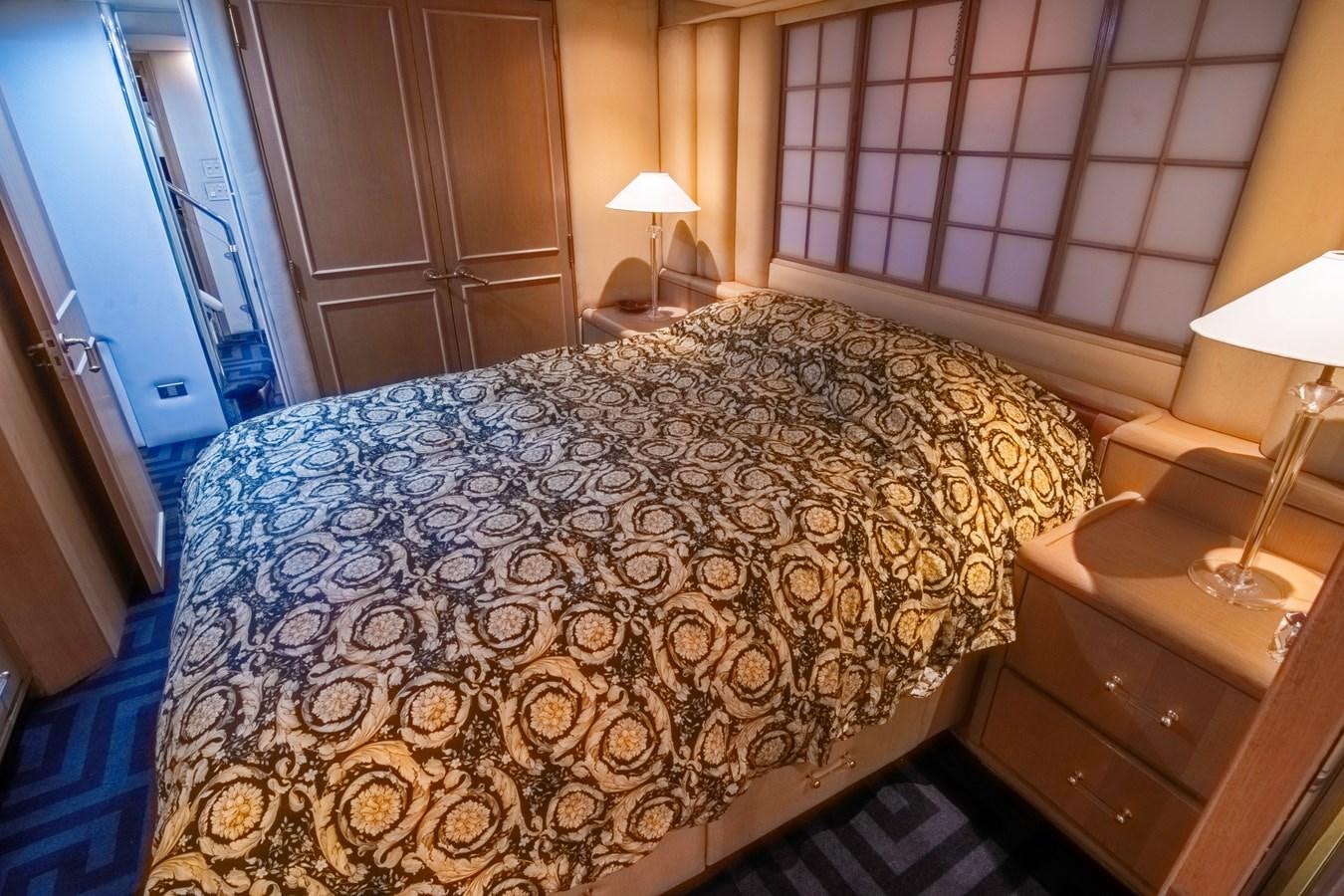 a bed with a white comforter aboard LADY AUDREY Yacht for Sale