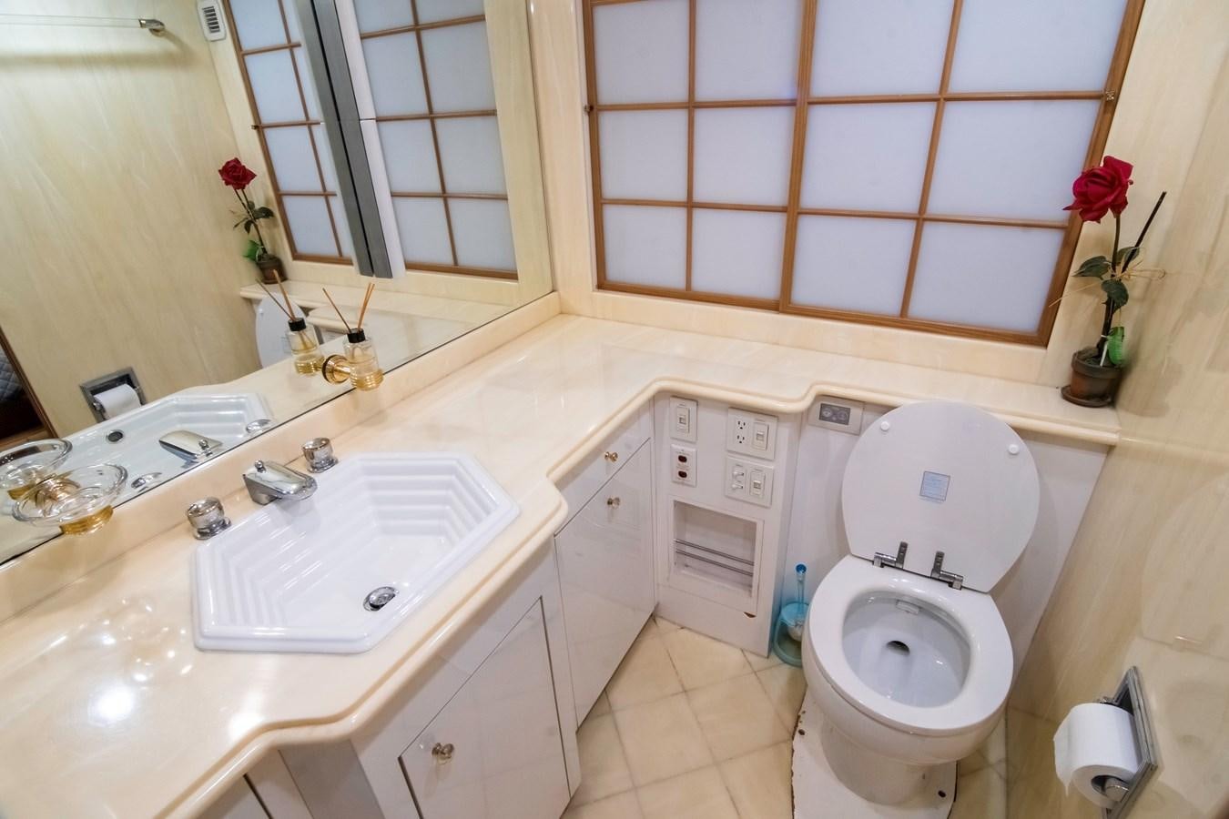 a bathroom with a toilet sink and a mirror aboard LADY AUDREY Yacht for Sale