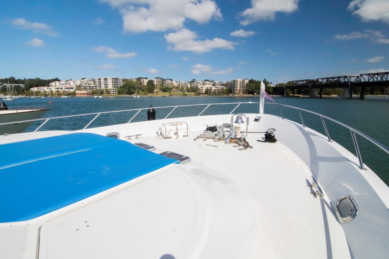 a large pool with a beach and a bridge in the background aboard LADY AUDREY Yacht for Sale