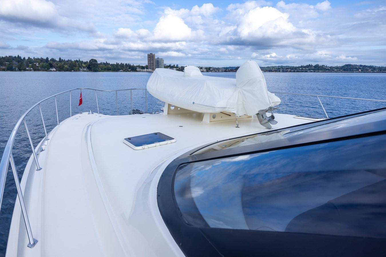 a boat with a white cover on the front aboard WHITE LIGHTNING Yacht for Sale
