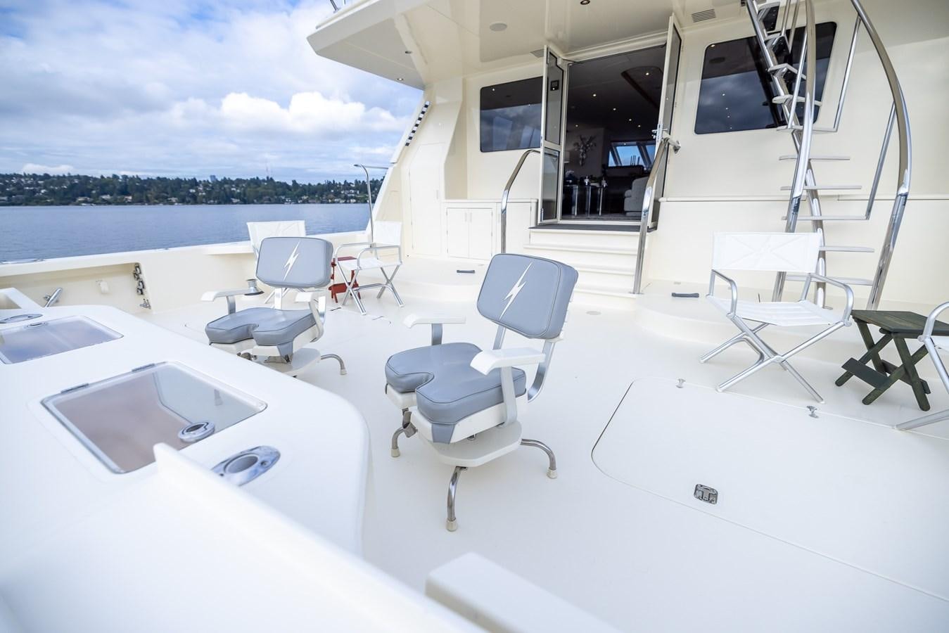 a room with a large white table and chairs and a large window aboard WHITE LIGHTNING Yacht for Sale
