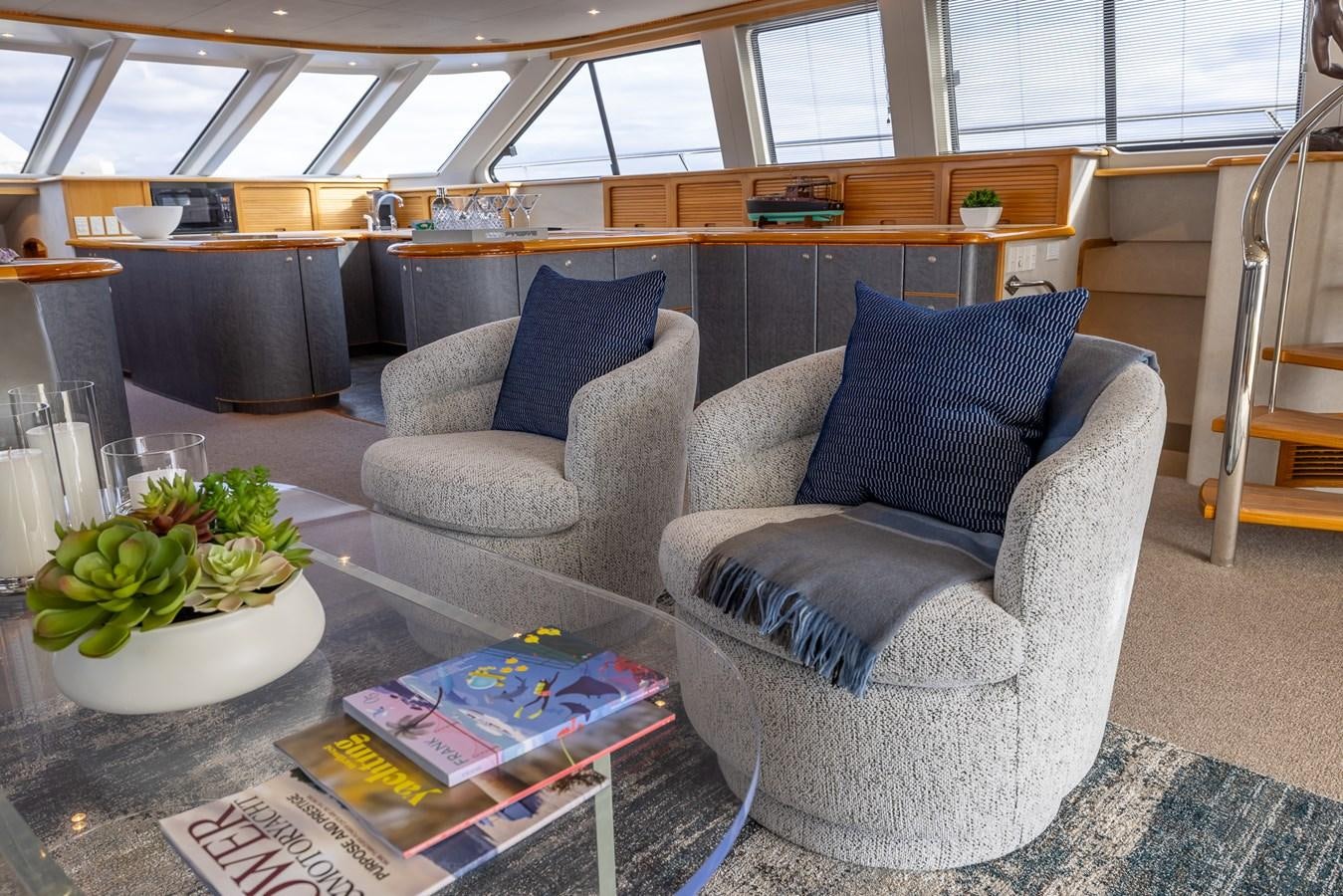 a living room with a couch and a table aboard WHITE LIGHTNING Yacht for Sale