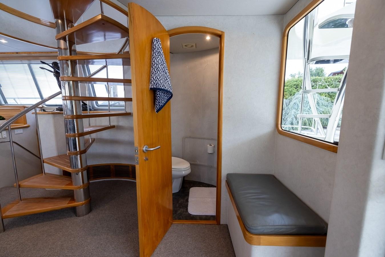 a room with a bunk bed and a chair aboard WHITE LIGHTNING Yacht for Sale