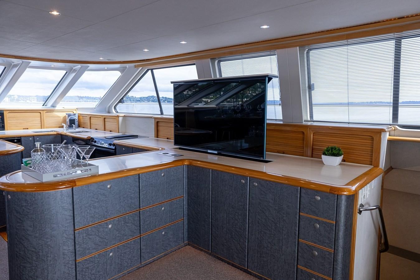 a kitchen with a tv and cabinets aboard WHITE LIGHTNING Yacht for Sale