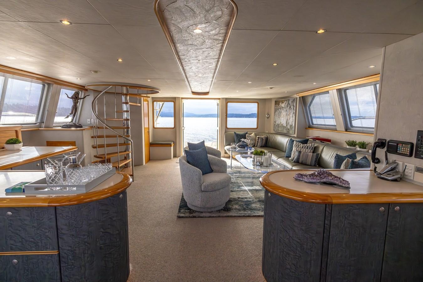 a living room with a ladder aboard WHITE LIGHTNING Yacht for Sale