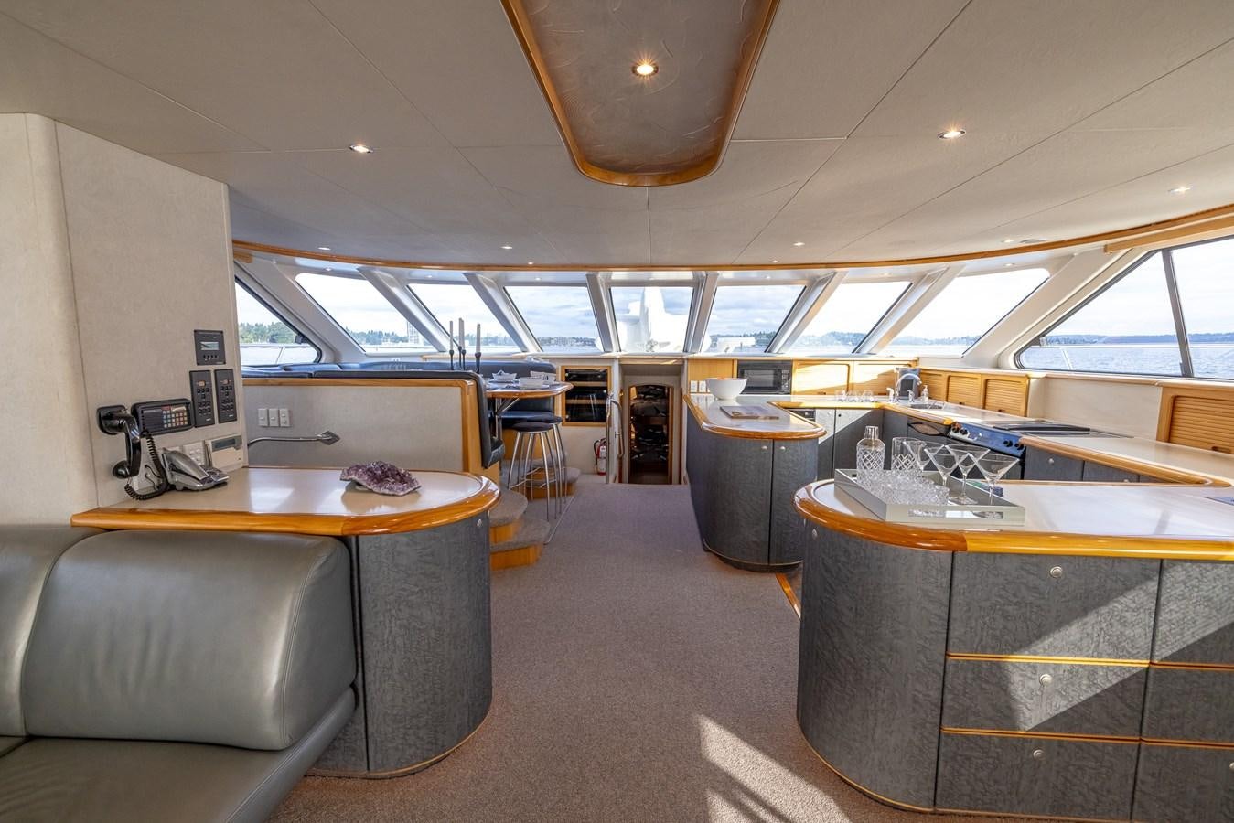a room with a table and chairs aboard WHITE LIGHTNING Yacht for Sale