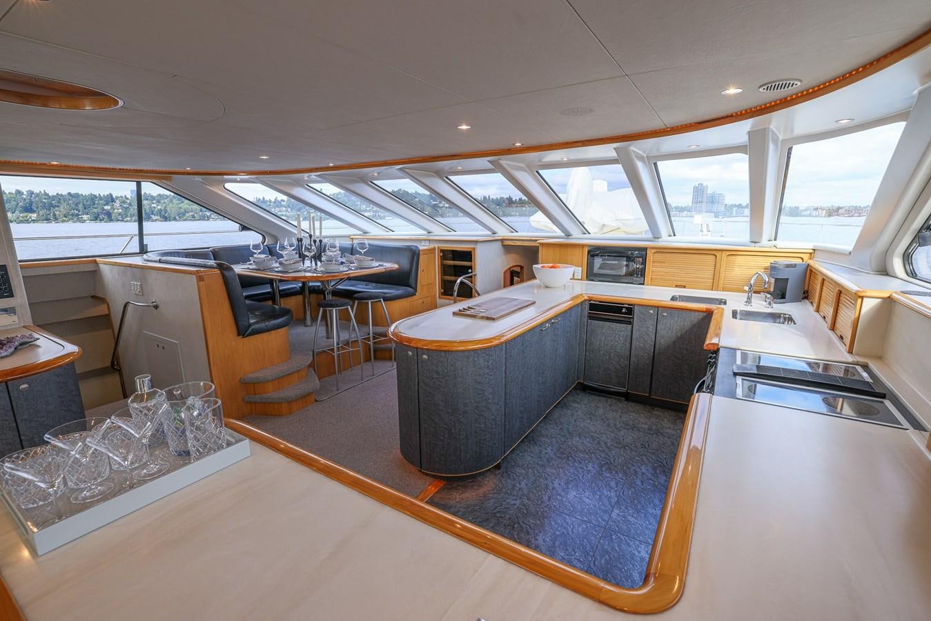 a large kitchen with a bar and a large window aboard WHITE LIGHTNING Yacht for Sale
