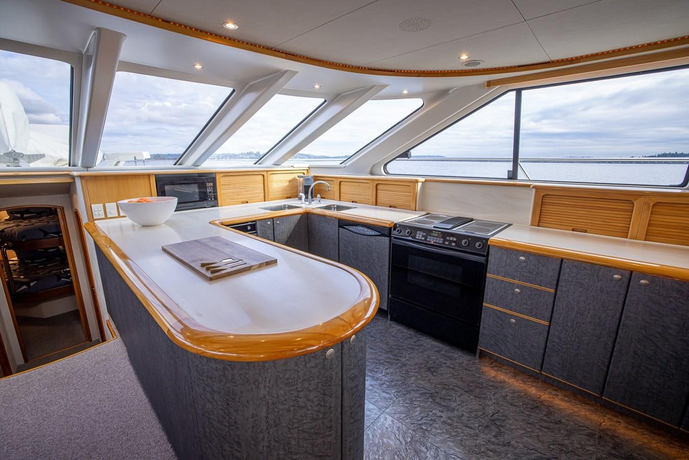 a kitchen with a large island aboard WHITE LIGHTNING Yacht for Sale