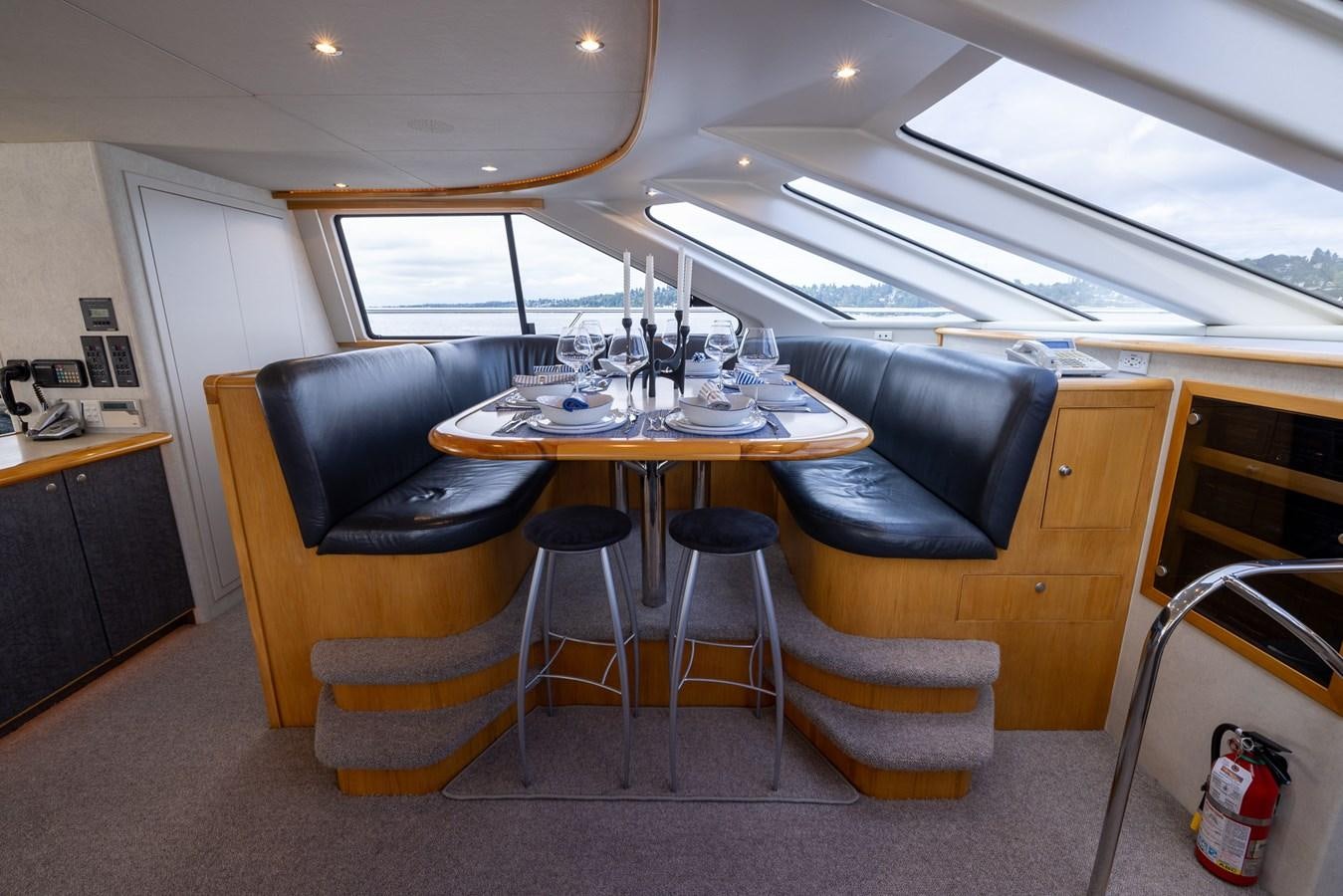 a room with a table and chairs aboard WHITE LIGHTNING Yacht for Sale