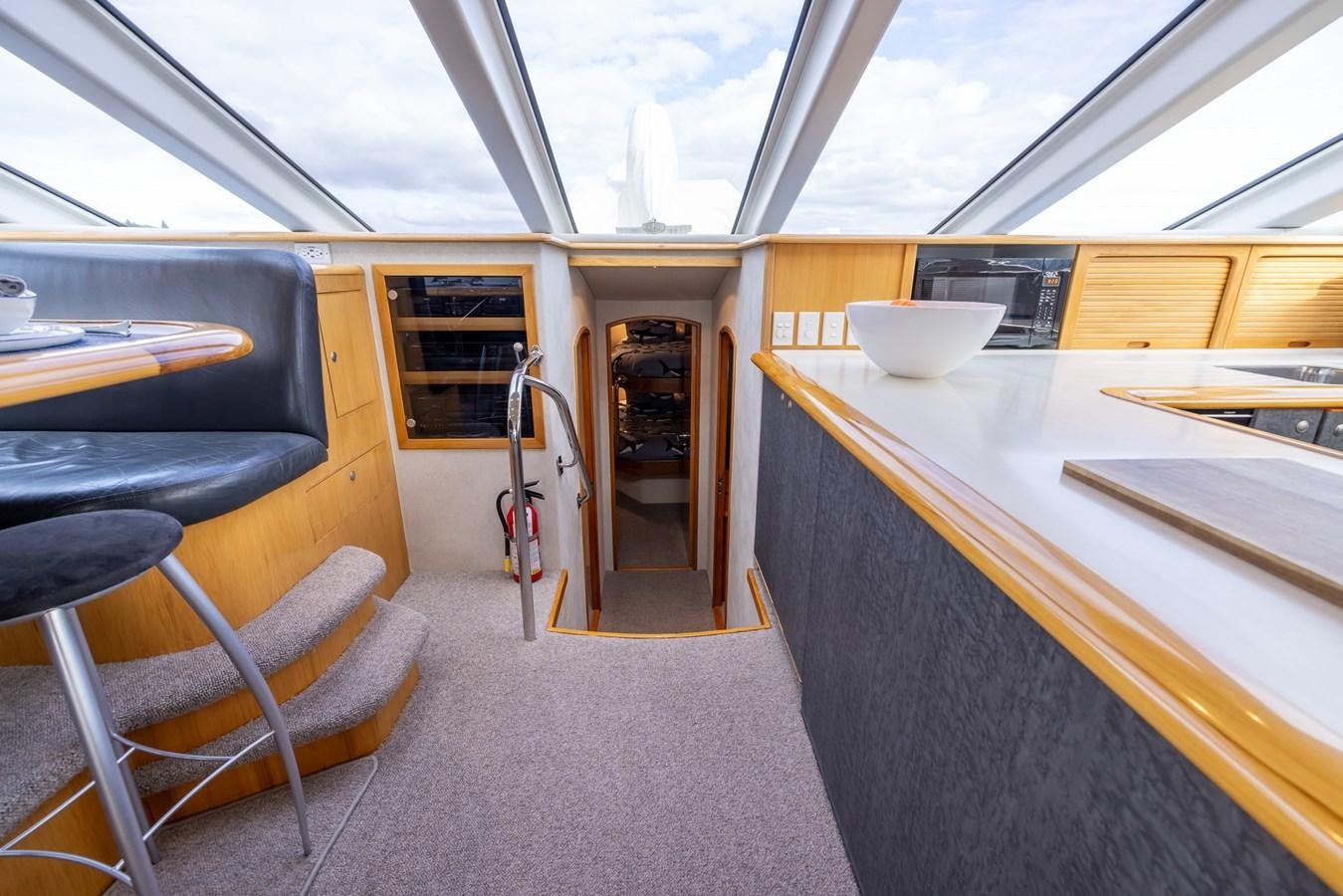 inside of a vehicle with a table and chairs and a door aboard WHITE LIGHTNING Yacht for Sale