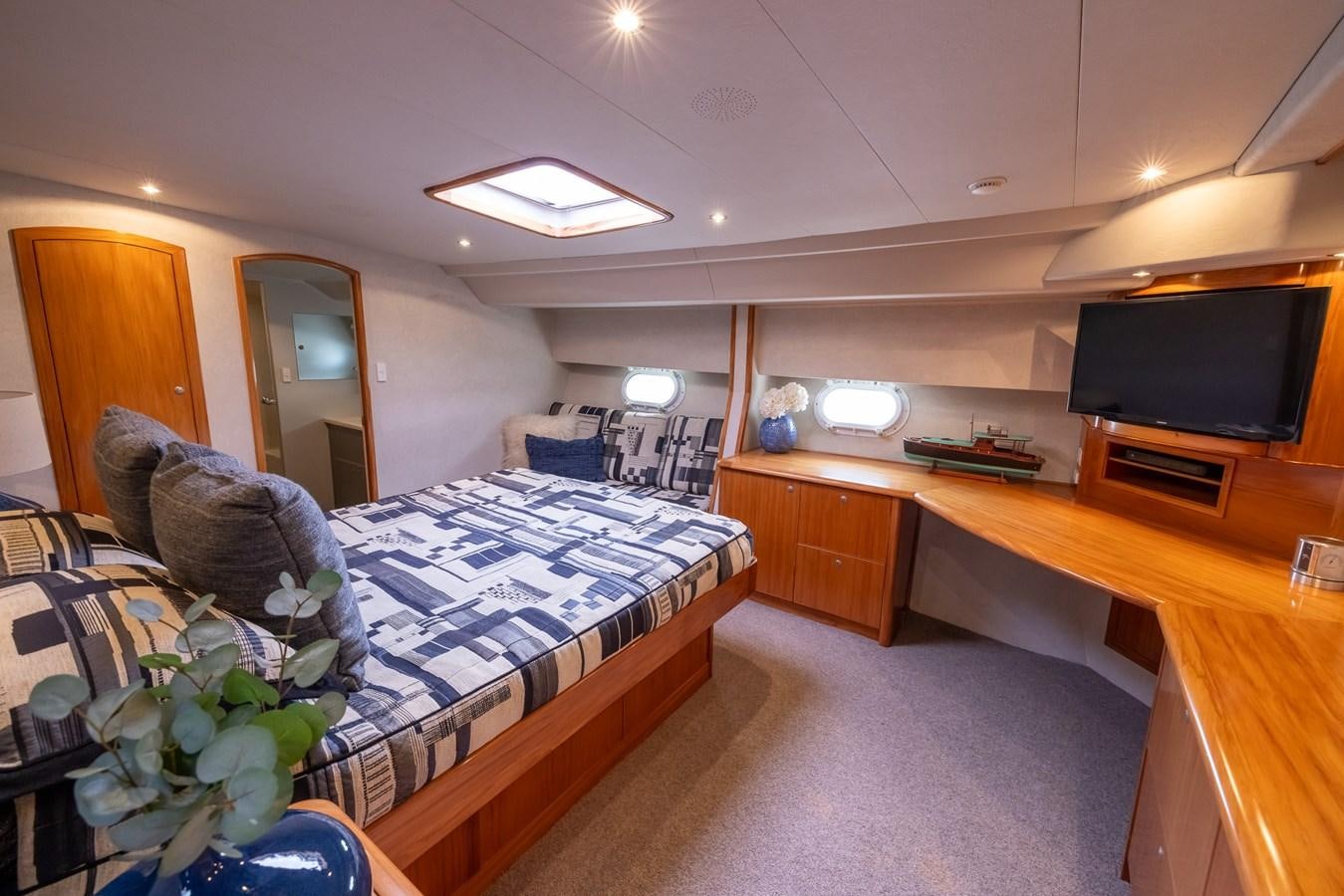 a bedroom with a bed and desk aboard WHITE LIGHTNING Yacht for Sale