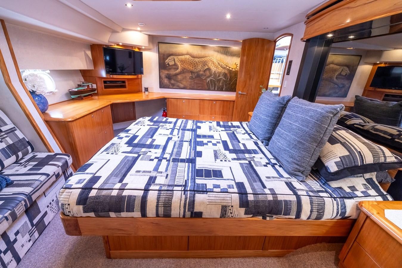 a bed with blue sheets aboard WHITE LIGHTNING Yacht for Sale