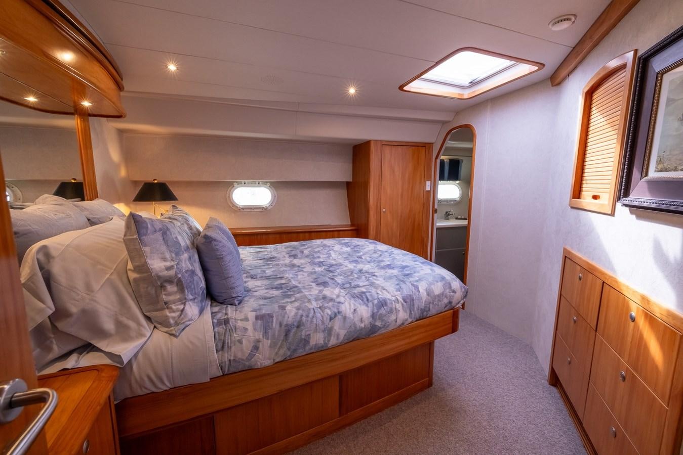 a bedroom with a bed and a desk aboard WHITE LIGHTNING Yacht for Sale