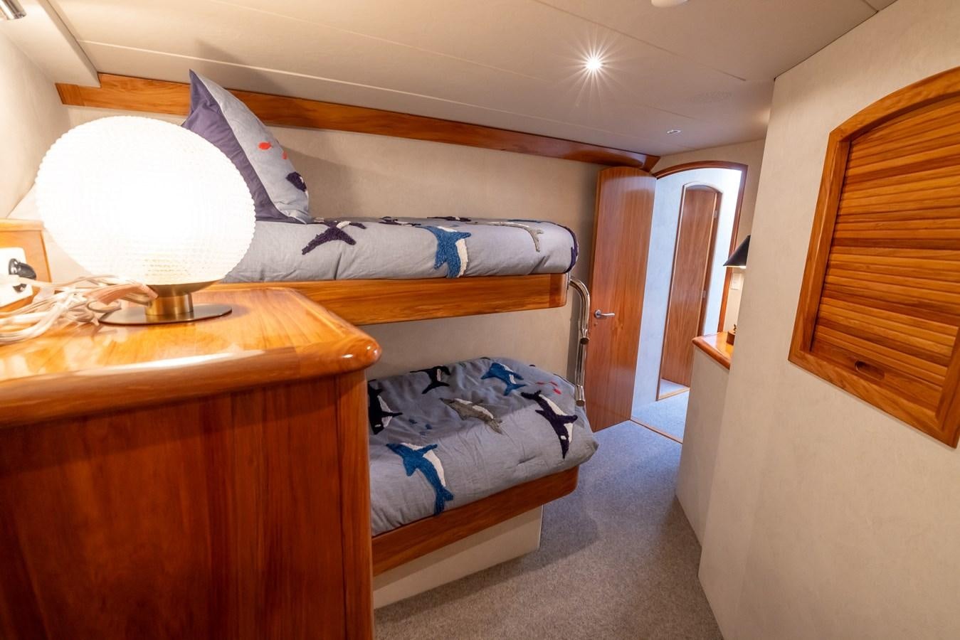 a room with a bed and a lamp aboard WHITE LIGHTNING Yacht for Sale