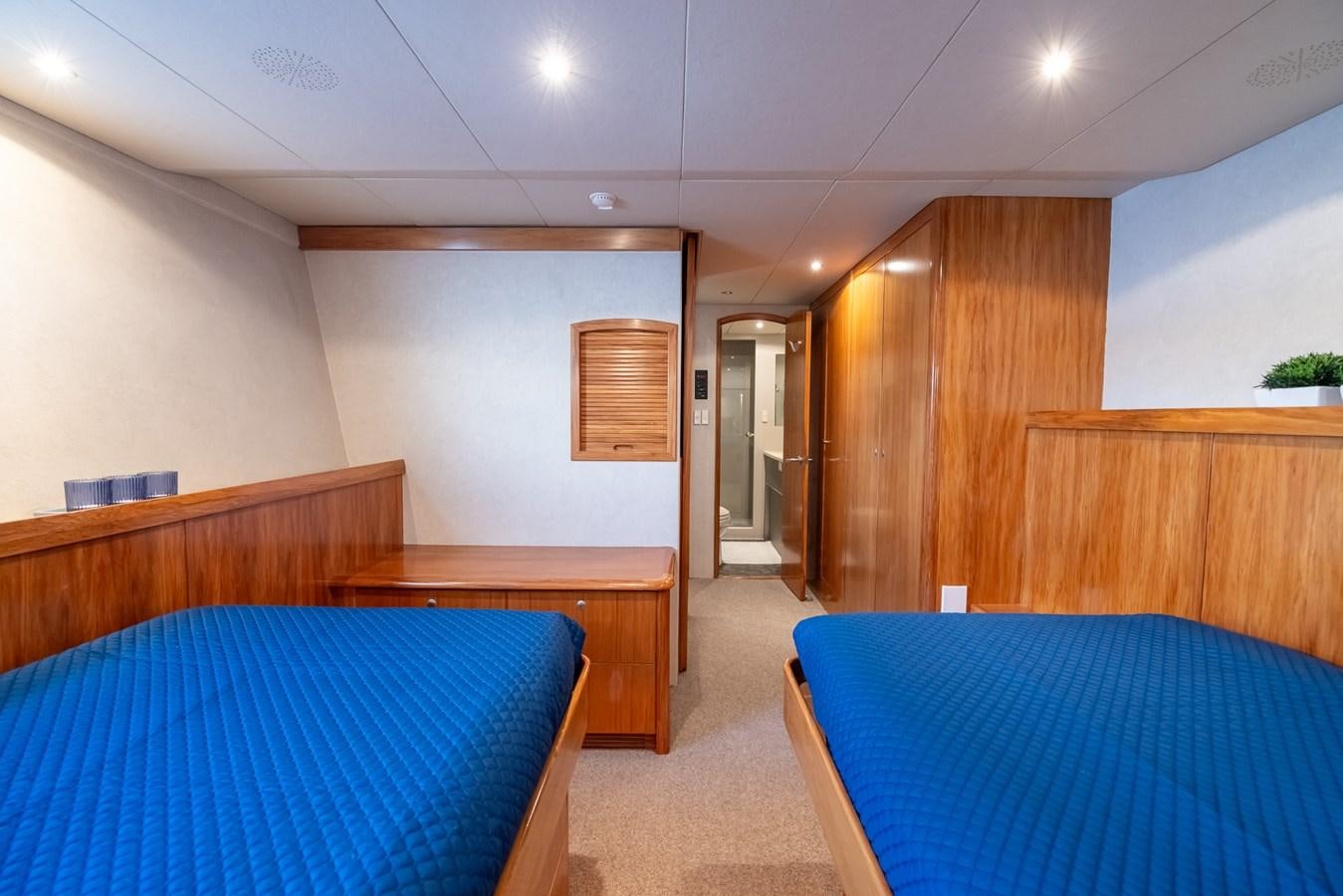 a room with a bed and a desk aboard WHITE LIGHTNING Yacht for Sale
