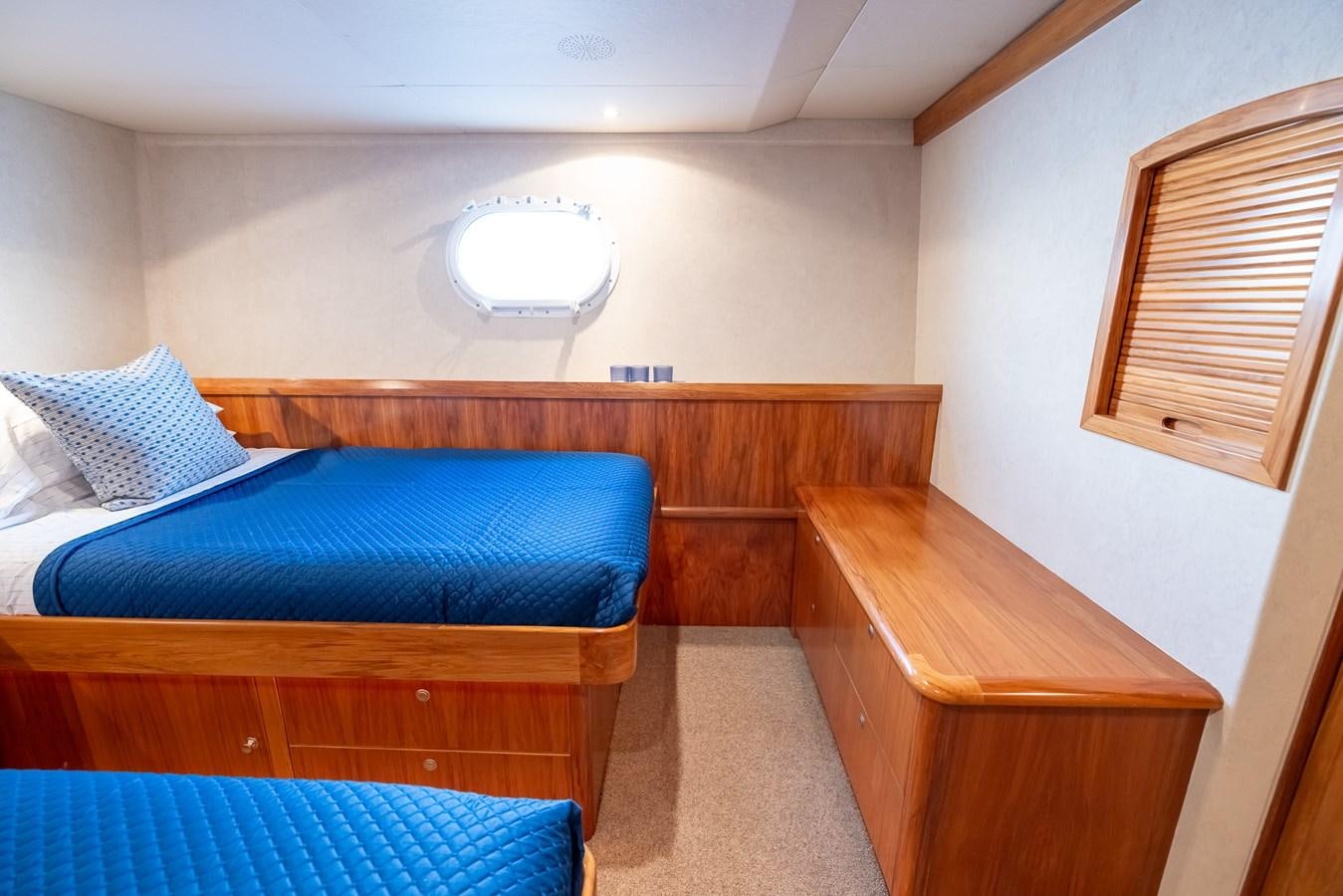 a bedroom with a bed and a desk aboard WHITE LIGHTNING Yacht for Sale