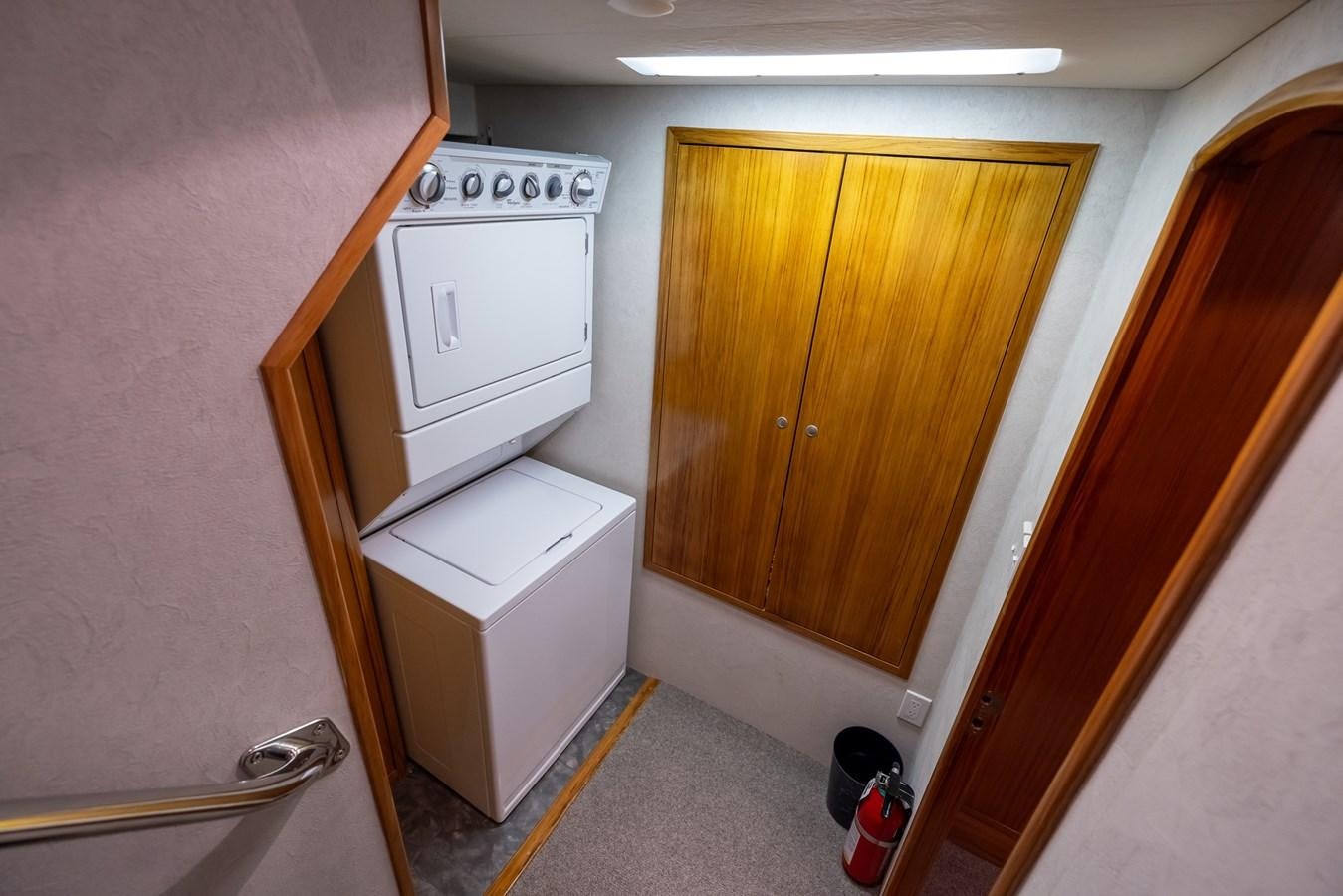 a small kitchen with a washing machine aboard WHITE LIGHTNING Yacht for Sale