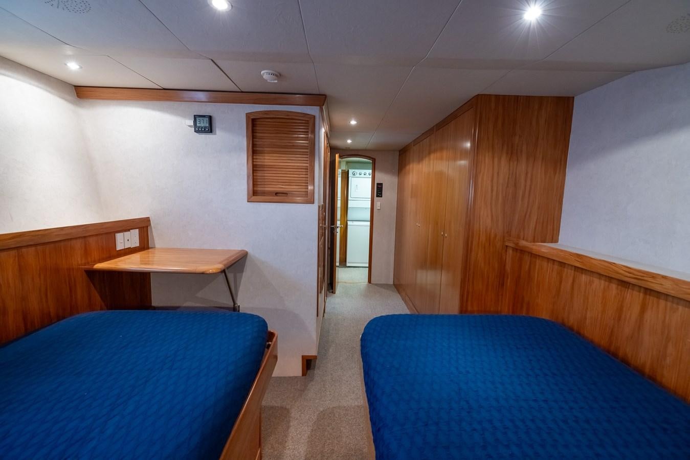 a room with a bed and a desk aboard WHITE LIGHTNING Yacht for Sale