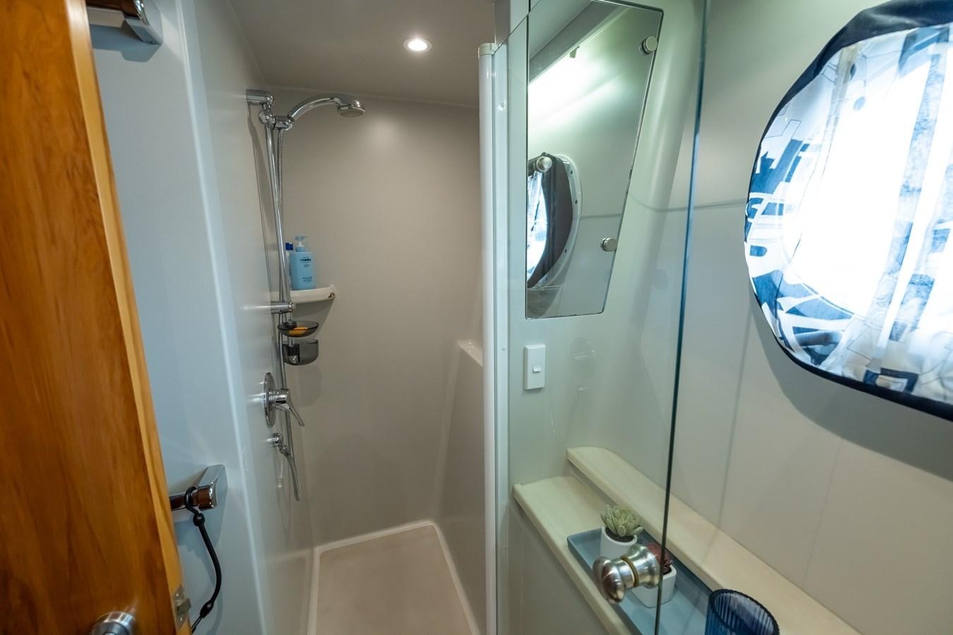 a bathroom with a shower and a sink aboard WHITE LIGHTNING Yacht for Sale