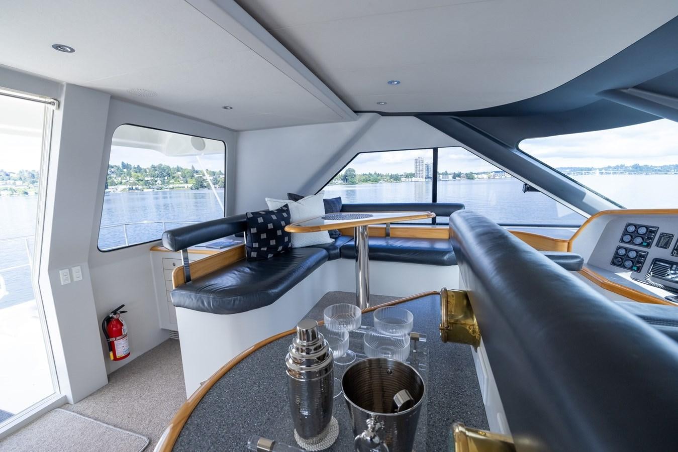 a table with a couple of glasses on it aboard WHITE LIGHTNING Yacht for Sale