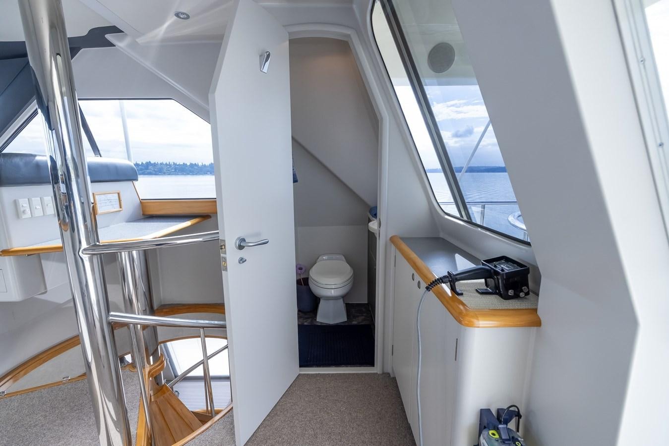 a room with a toilet and a ladder aboard WHITE LIGHTNING Yacht for Sale