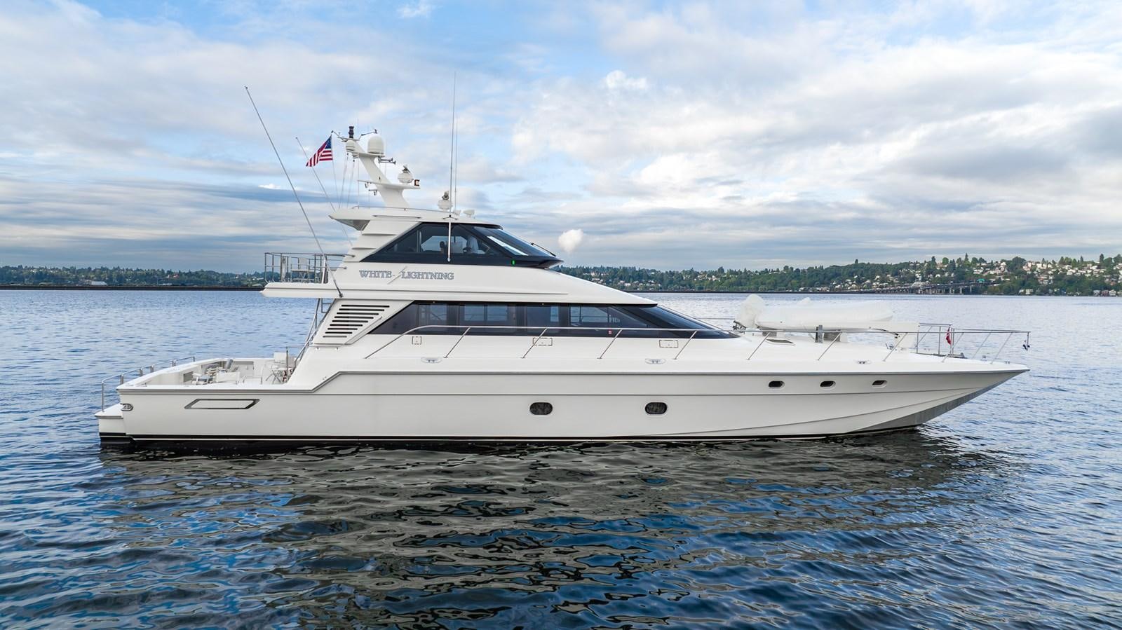 a white yacht on the water aboard WHITE LIGHTNING Yacht for Sale