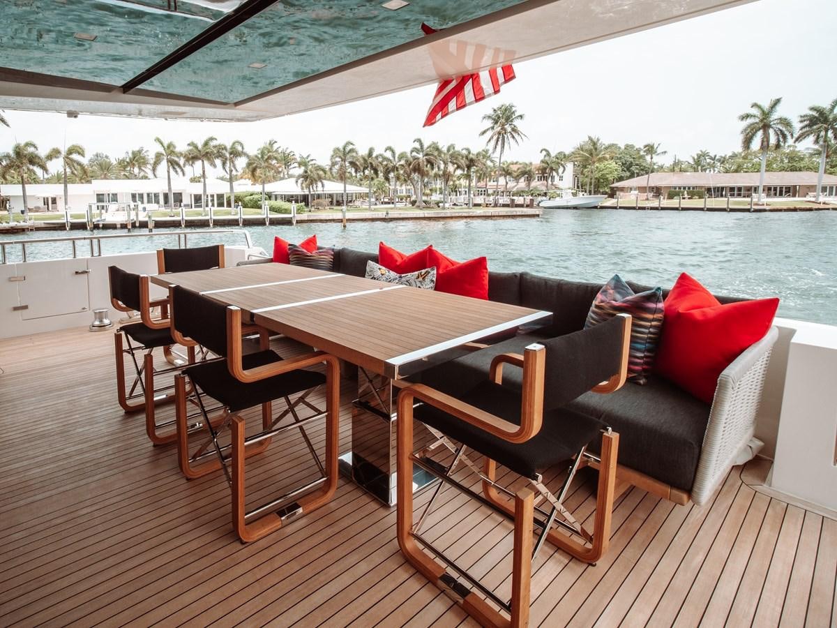 a table and chairs on a deck aboard FIFTY SHADES Yacht for Sale