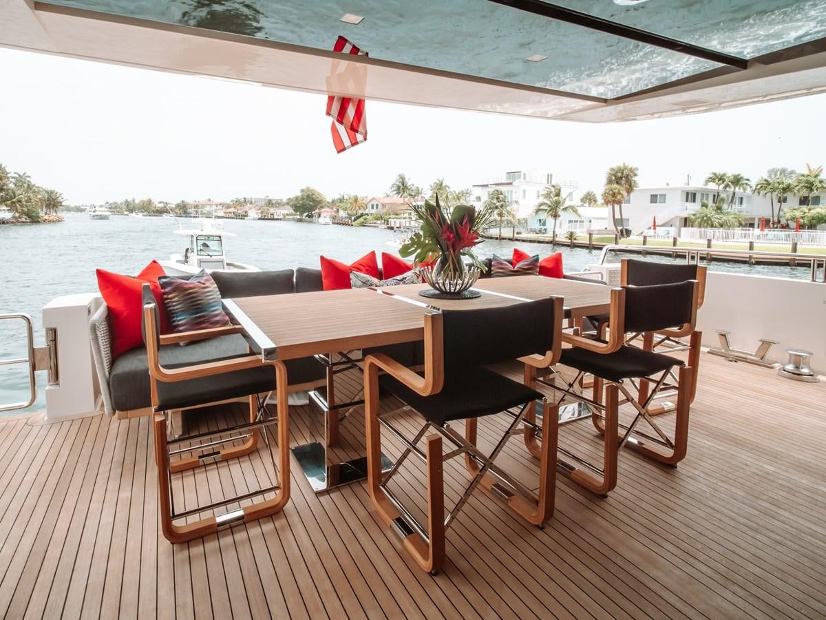 a table and chairs on a deck aboard FIFTY SHADES Yacht for Sale