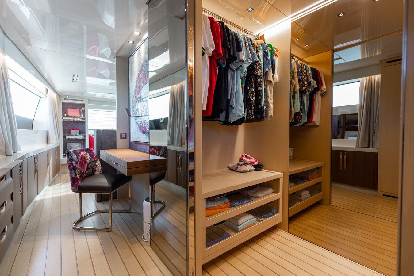 a closet with clothes on the wall aboard FIFTY SHADES Yacht for Sale