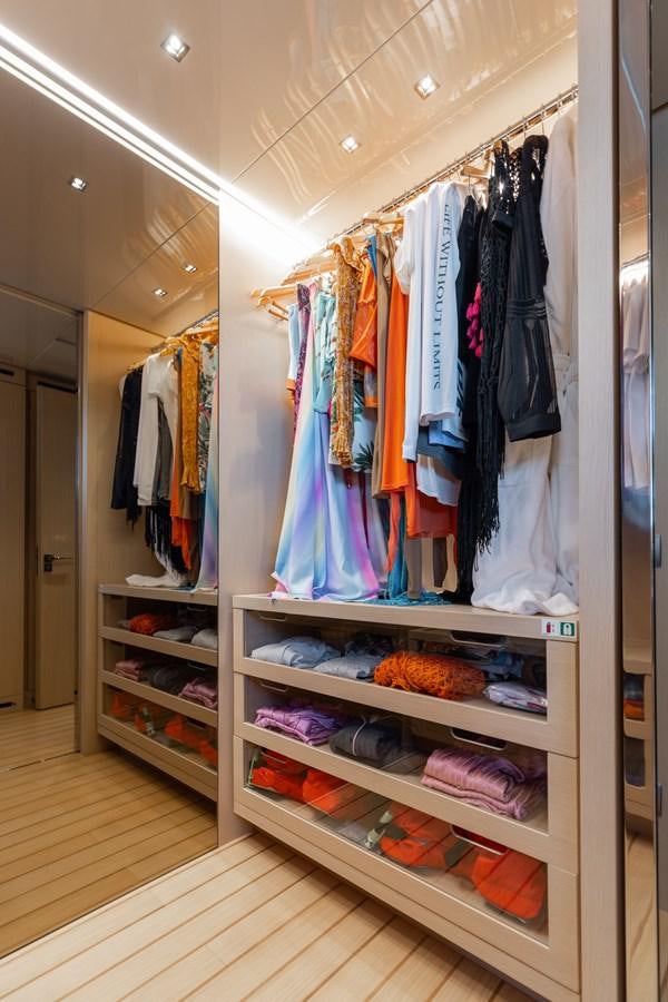 a closet with clothes on the wall aboard FIFTY SHADES Yacht for Sale