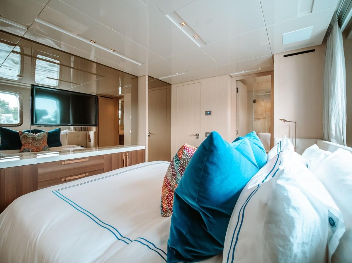 a room with a bed and a television aboard FIFTY SHADES Yacht for Sale