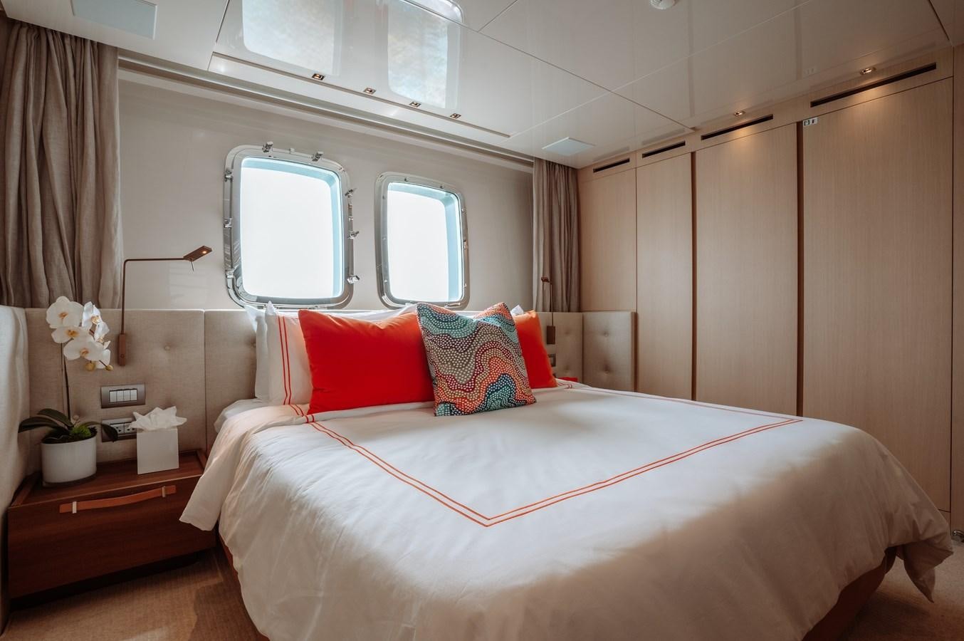 a bed with red pillows aboard FIFTY SHADES Yacht for Sale