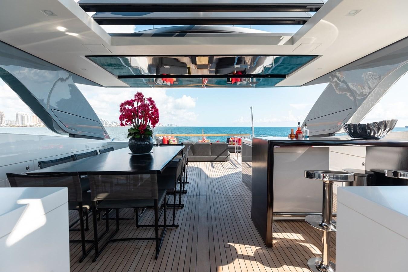inside of a building with a large window and a table with flowers aboard FIFTY SHADES Yacht for Sale