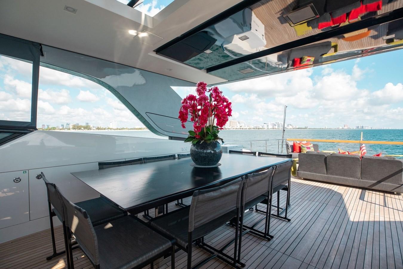 a table with flowers on it aboard FIFTY SHADES Yacht for Sale