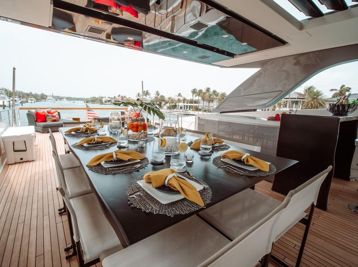 a table with plates and glasses on it aboard FIFTY SHADES Yacht for Sale