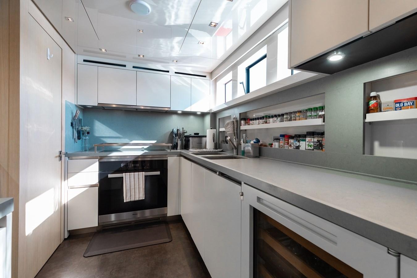 a kitchen with white cabinets aboard FIFTY SHADES Yacht for Sale