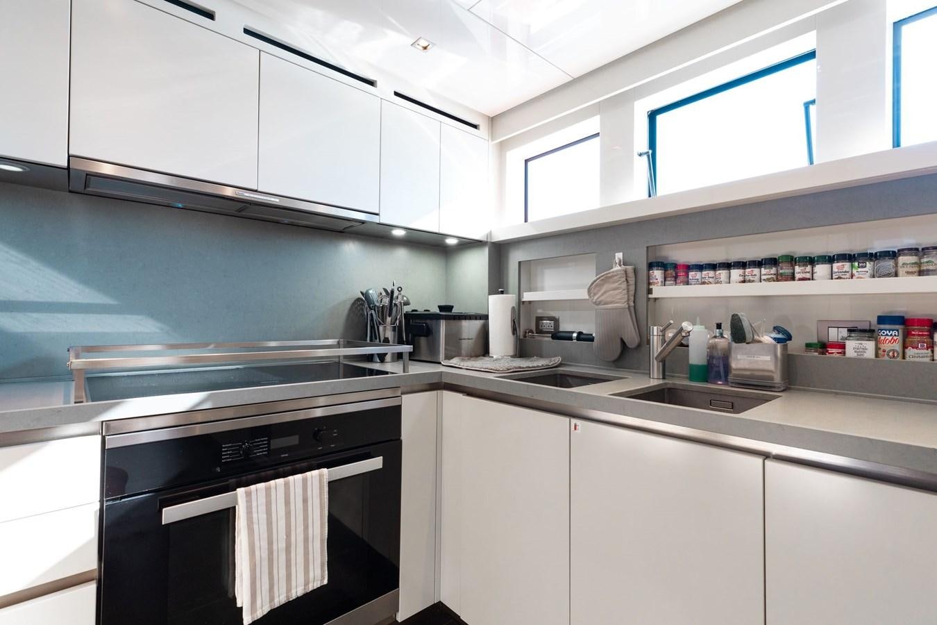 a kitchen with white cabinets aboard FIFTY SHADES Yacht for Sale